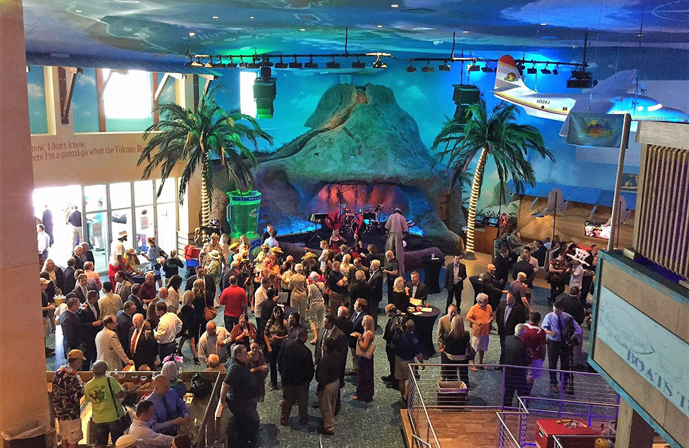 Large group of people inside Margaritaville near the volcano stage mingling, drinking and eating